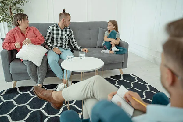 Family therapy session with parents and children