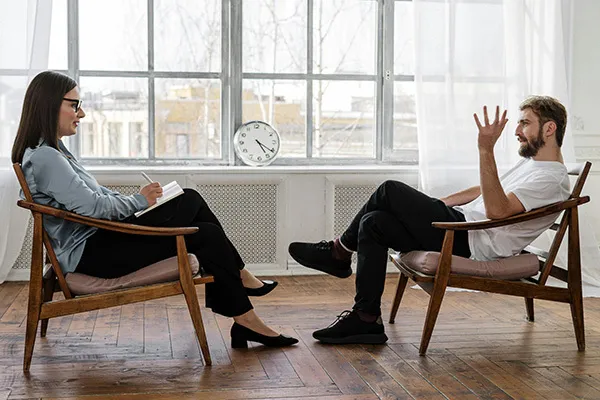 Psychotherapy session with therapist and client